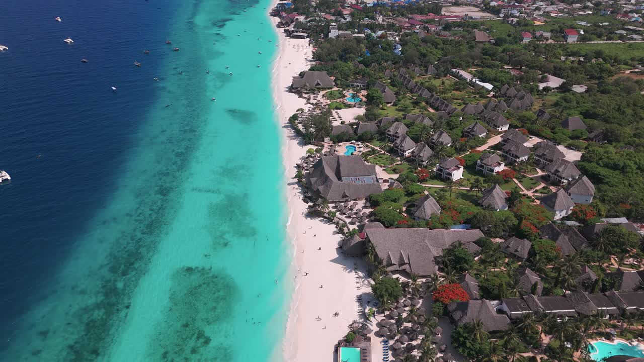 Thatched Roof Bungalows At The Hotel Resorts On Nungwi In Zanzibar, Tanzania. Aerial Drone Shot