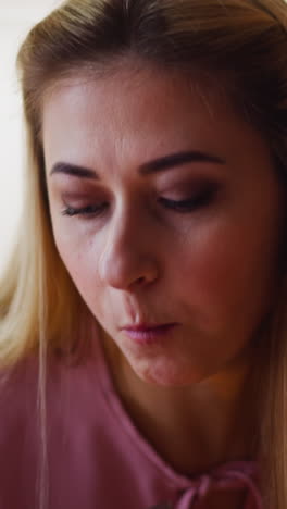 elegant woman eats tasty salad and drinks collectible red wine sitting at table during holiday dinner at decorated room closeup slow motion