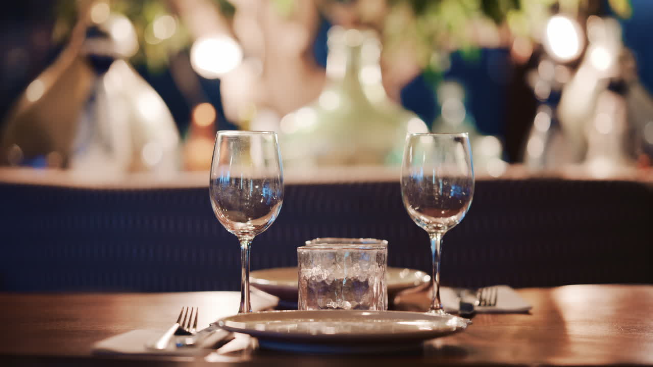 Woman with long wavy hair, viewed from behind as she looks at pastries through the display glass