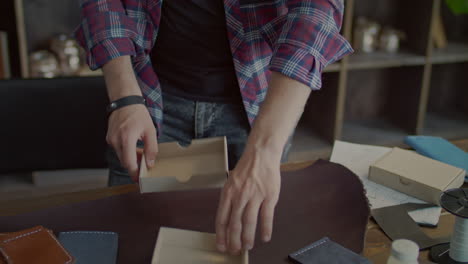 manual worker folding cardboard box