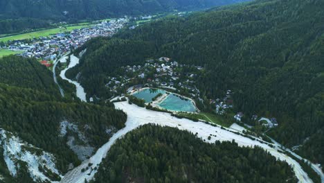 small water pond in icy glacier part of alps, aerial drone view