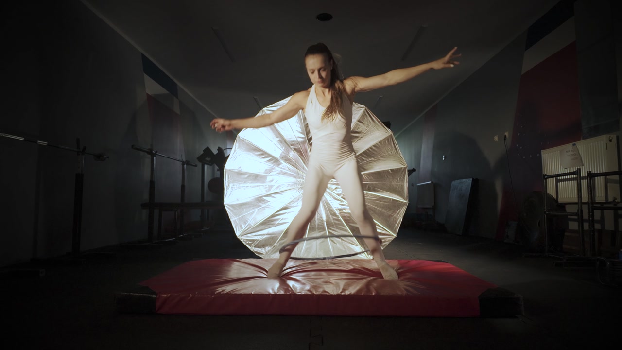 Young woman practicing and failing doing hola hoop. Slow motion