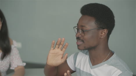 Black-Boy-Speaking-To-A-Multicultural-Group-And-High-Fiving-With-Them