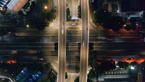 Rising-Aerial-timelapse-of-busy-intersection-at-night---Kuningan-city,-Jakarta