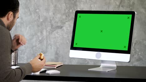 senior businessman choking in front of his computer. green screen mock-up display