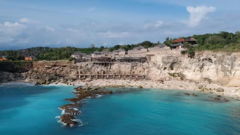 drone flying over tropical blue lagoon in nusa ceningan, indonesia