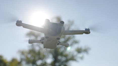 drone flying in air with sun flares around it