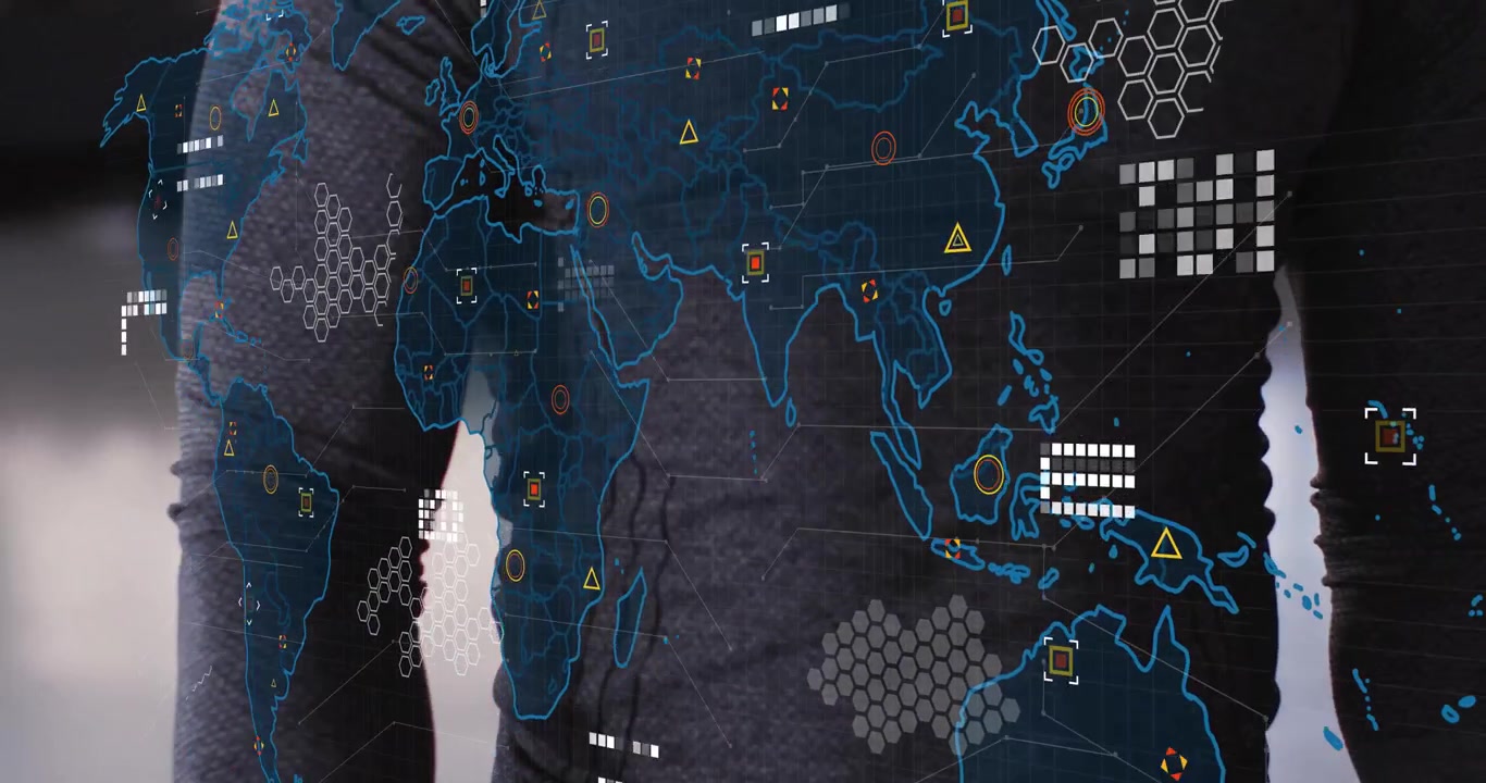 man wearing grey athletic top standing behind digital world map overlay, showing tech data markers