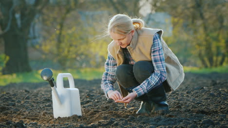 a woman farmer planting seeds in his garden spring work