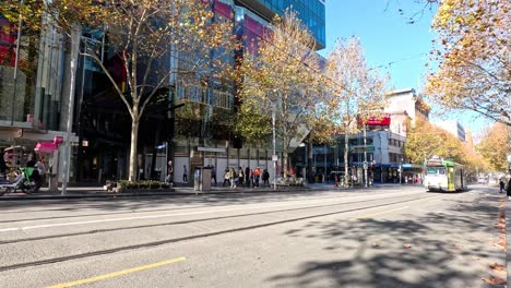 a tram travels down swanston street in melbourne