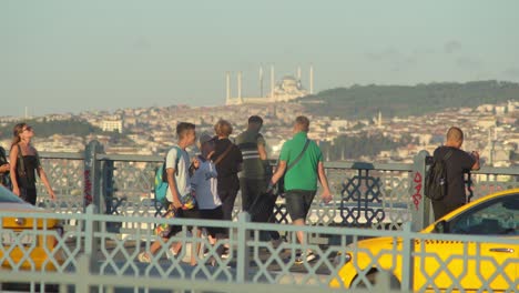 man standing near fence against a background of istanbul skyline view