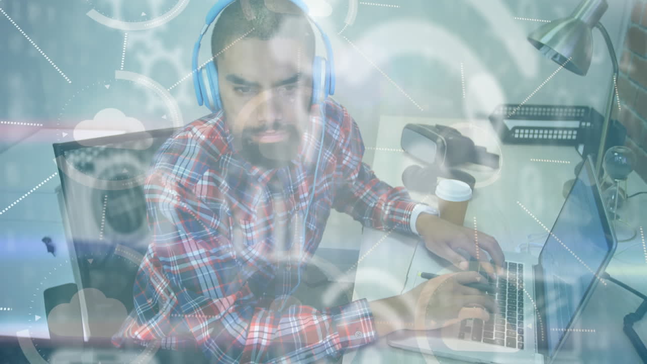 Digital composite video of network of connections icons against man wearing headphones using laptop