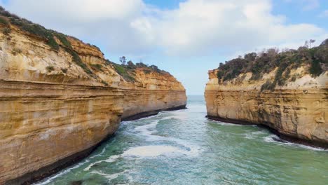 drone footage captures the dramatic cliffs and turbulent waters of loch ard gorge, showcasing natural erosion and stunning coastal scenery