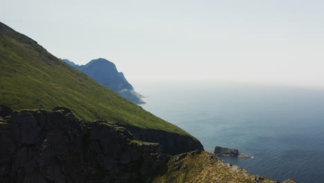 Cinematic-drone-shot-flying-over-mountain-cliffs-at-Horseid-Beach