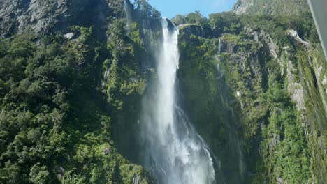 Nature&#039;s cascade: Moving down waterfall at Milford Sound in captivating stock footage