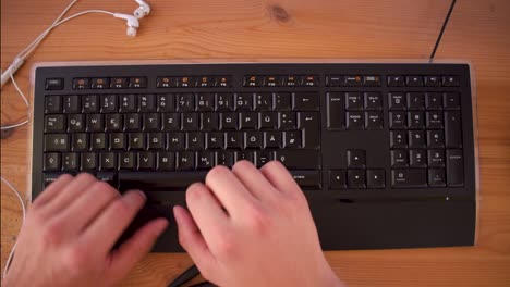 young man is writting a text on his computer using a keyboard-7