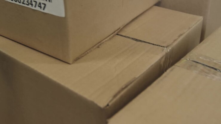 Animation of data processing over cardboard boxes in warehouse