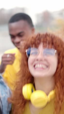 multi-ethnic excited friends dancing together in the street
