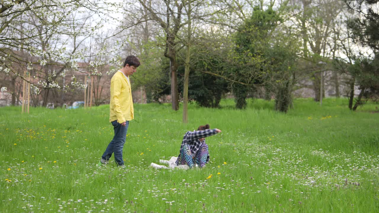 Two Teenagers Relaxing in a Park