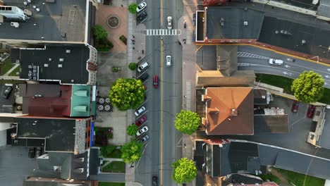 cars on street of american town in spring. goldene sunset in center of town. row of houses with colorful facade in ephrata, pa, united states. landing top down shot.