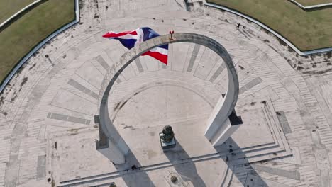 high angle and slow-motion of dominican republic flag waving in plaza de la bandera, santo domingo