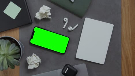 modern workspace with green screen phone and mousepad