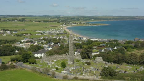 Aerial-view,4K,-pan-left,-Ardmore-Round-Tower-built-in-the-12th-century-and-the-ruins-of-a-Cathedral-dating-from-the-12th-and-13th-centuries