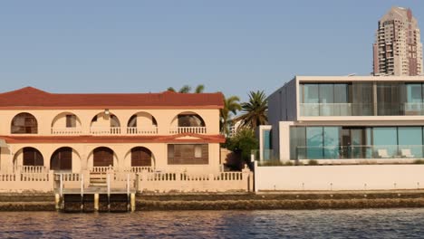 progression of various waterfront homes along a river