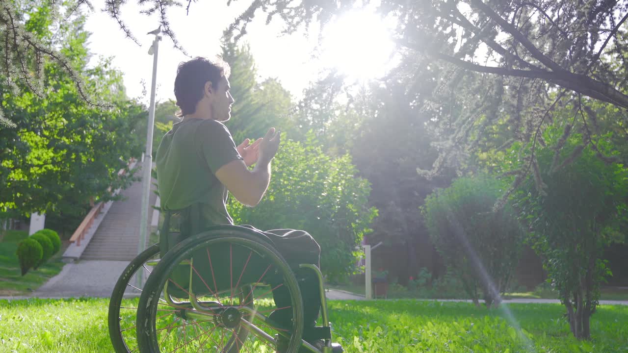 Disabled youth sitting in a wheelchair praying.