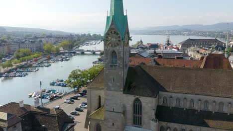 aerial establishing shot of fraumünster church with limmat river and lake zurich in background