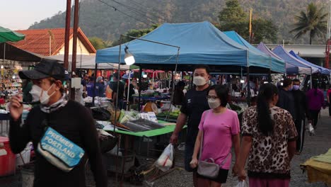 shoppers and vendors at a busy outdoor market