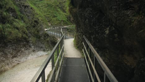 Wooden-guard-rail-guides-you-along-path-on-side-of-river-gorge-in-Almbachklamm-Germany