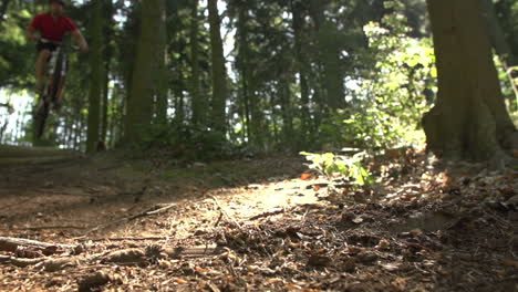 slow motion shot mountain biker making dramatic jump