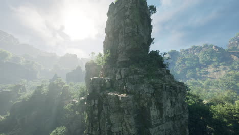 a rocky mountain peak overlooking a lush forest valley