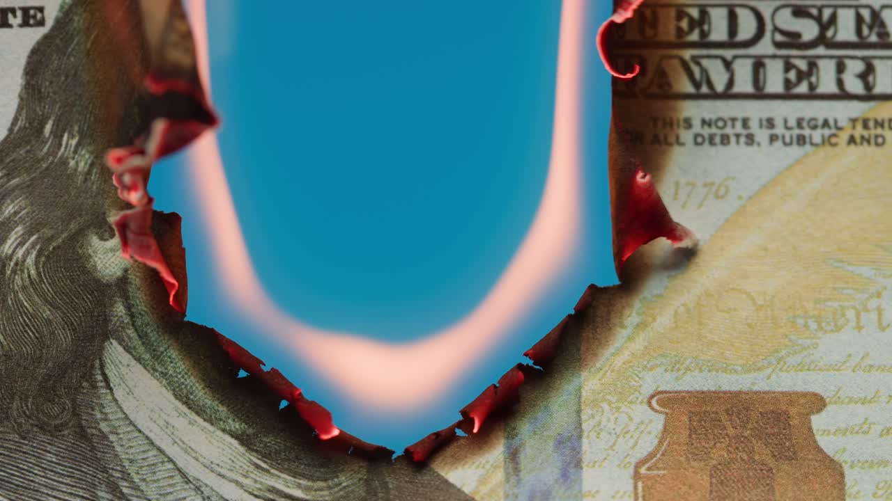 Close-Up of a Hundred Dollar Bill Burning