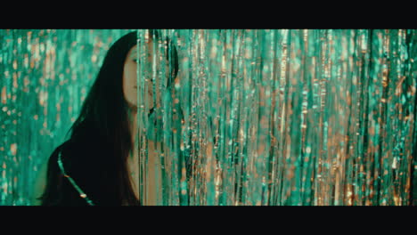 woman behind gold tinsel