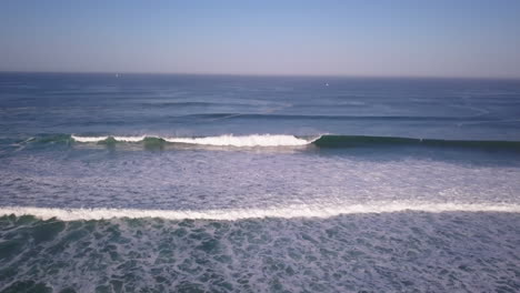 Cinematic-aerial-drone-stunning-Quik-Pro-coastline-morning-huge-glassy-waves-swell-barrels-crashing-by-shore-Hossegor-Seignosse-France-Biarritz-Basque-Country-backwards-movement