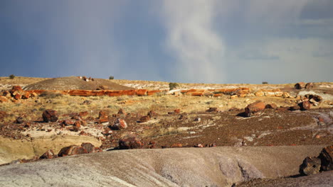 Looking-out-across-the-landscape-of-Petrified-Forest-National-Park,-storm-clouds-on-the-horizon