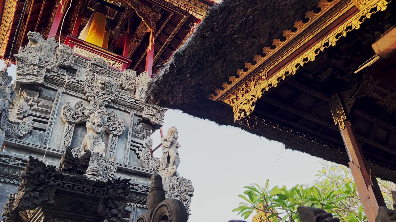 Ancient stone carvings adorn this Bali temple, a spiritual retreat where culture and nature merge, inviting travelers to pause, reflect, and connect with history and tradition.