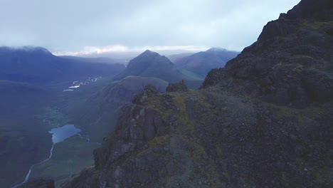 Flying-close-to-a-photographer,-who-is-capturing-the-beautiful-scene-at-Isle-of-Skye,-Scotland