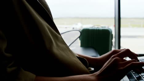 businesswoman using laptop at airport