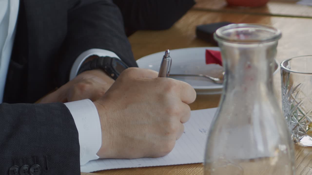 um empresário faz anotações durante uma reunião da empresa