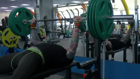 person bench pressing in a gym