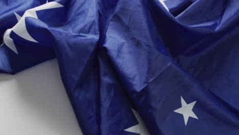 Video-of-creased-flag-of-australia-lying-on-white-background
