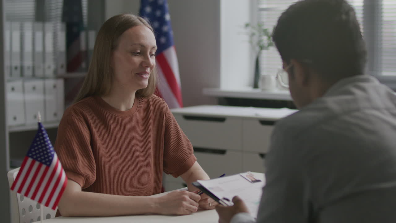 Woman Having Visa Interview with Consular Officer at US Embassy