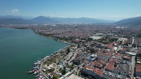 Drone-shot-of-Fethiye-city-with-walking-promenade-and-cars-in-the-Turkish-Riviera