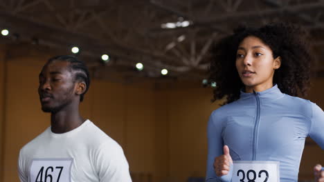 man and woman running indoors