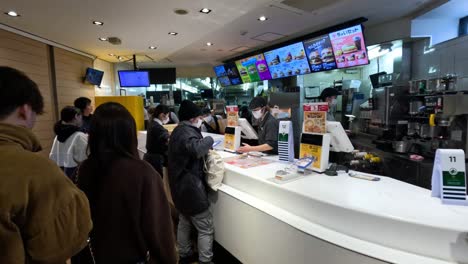 customers ordering food at a fast food counter