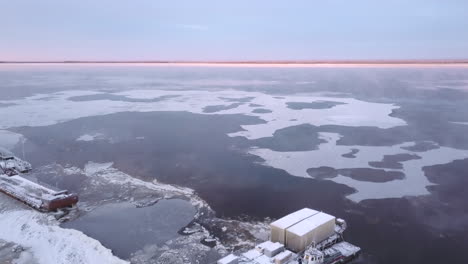 frozen river with shipping barge in winter
