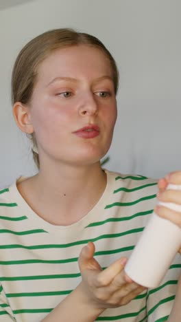 woman demonstrating facial cleanser